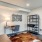 home office area with desk and shelves 